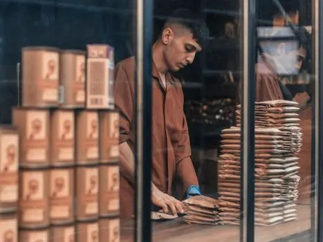 She is a shop assistant — она работает продавщицей в магазине.